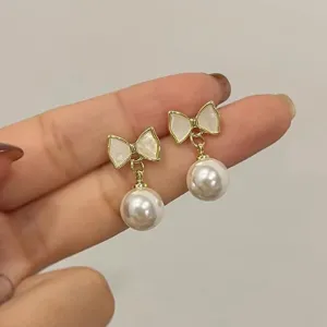 Women's pearl bow earrings